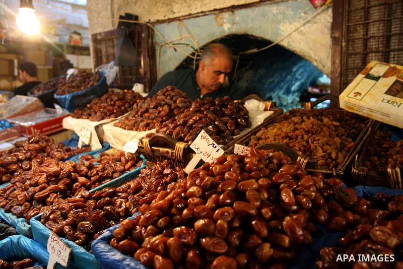 A Palestinian vendor sells dates in his shop at a market in the West Bank city of Nablus, on Aug. 10, 2011. Muslims around the world are observing the holy fasting month of Ramadan where they refrain from eating, drinkin...