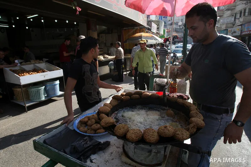A Palestinian vendor prepares traditional foods "falafel", in a market in the West Bank city of Nablus, on Aug. 10, 2011. Muslims around the world are observing the holy fasting month of Ramadan where they refrain from e...