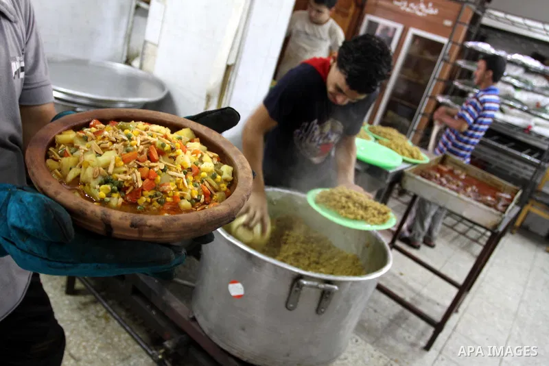 Palestinian bakers prepare rice and meat 'Qedrah" in a traditional stove at Beirut Kitchen in Gaza city on Aug. 10, 2011.during the holy fasting month of Ramadan, when observant Muslims abstain from eating, drinking and...