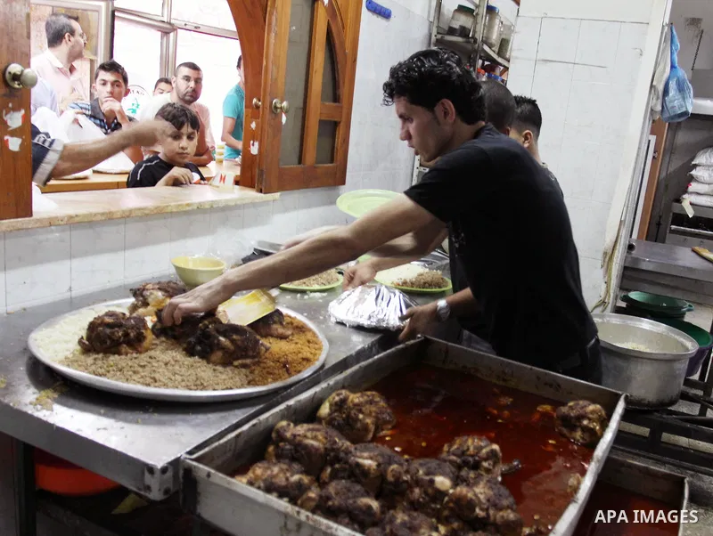 Palestinian bakers prepare chicken and rice 'Qedrah" in a traditional stove at Beirut Kitchen in Gaza city on Aug. 10, 2011, during the holy fasting month of Ramadan, when observant Muslims abstain from eating, drinking...