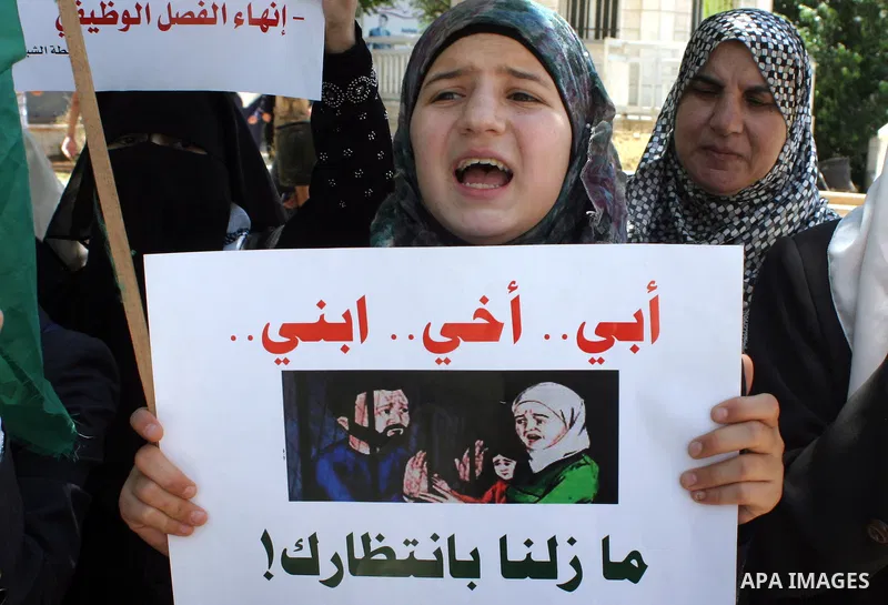 Palestinian Hamas supporters hold pictures of relatives who were arrested and imprisoned for political reasons by Palestinian Authority security forces, during a protest in the West Bank city of Hebron on Aug. 11, 2011....