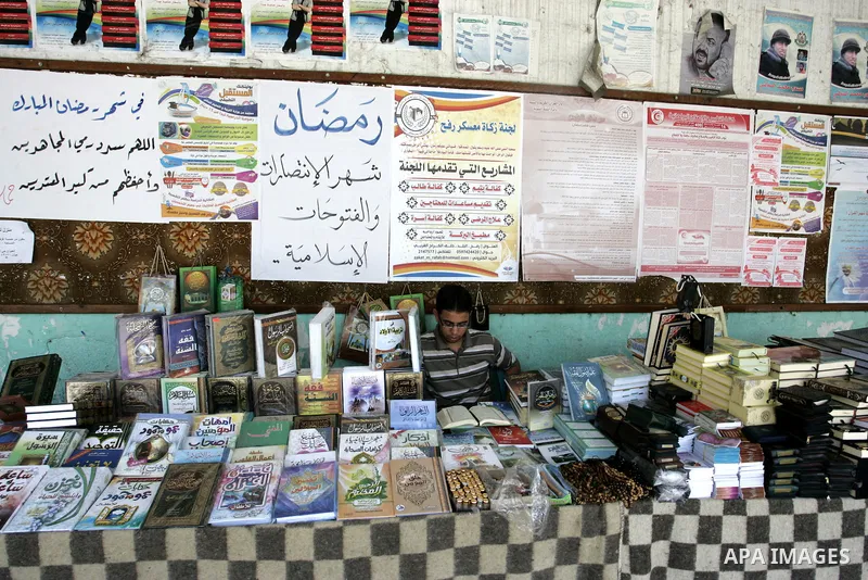 A Palestinian man reads the holy koran in his shop at a market in Rafah, southern Gaza Strip on Aug. 11, 2011. Muslims throughout the world are marking the month of Ramadan, during which they refrain from eating, drinkin...