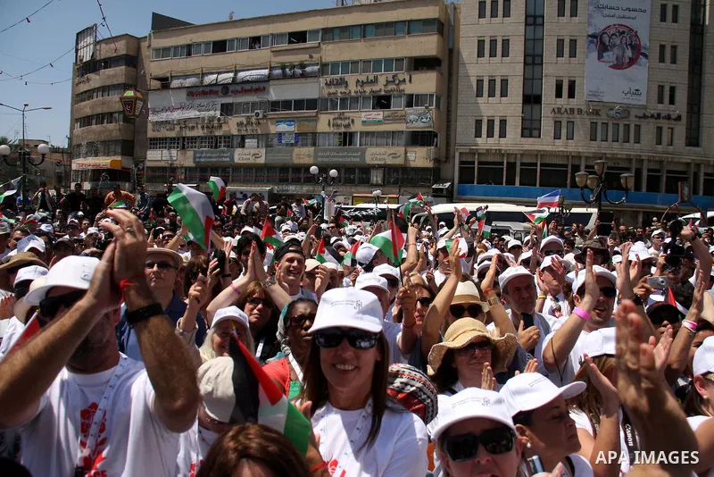 Foreign supporters with the Palestinian people take part in a demonstration in the West Bank city of Nablus, on Aug. 11, 2011. In support with the Palestinian people, where gather more than 1,200 activists from 22 foreig...