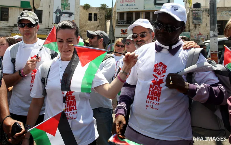 Foreign supporters with the Palestinian people take part in a demonstration in the West Bank city of Nablus, on Aug. 11, 2011. In support with the Palestinian people, where gather more than 1,200 activists from 22 foreig...