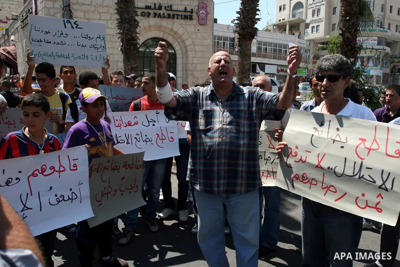 Palestinian activists hold a demonstration calling for boycotting the Israeli products from the Palestinian local markets in the West Bank city of Ramallah, on Aug. 11, 2011. Photo by Issam Rimawi