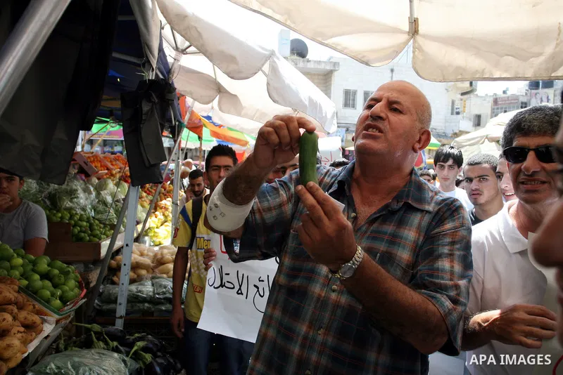 Palestinian activists hold a demonstration calling for boycotting the Israeli products from the Palestinian local markets in the West Bank city of Ramallah, on Aug. 11, 2011. Photo by Issam Rimawi