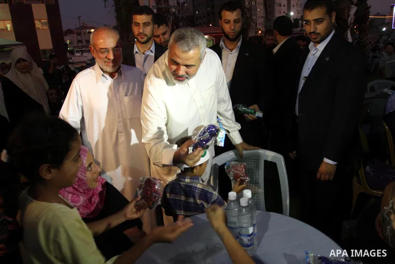 Palestinian Prime Minister in Gaza Strip, Ismail Haniya during his participation the collective meal "Iftar" with the orphans in the holiest month of Ramadan, where sponsoring by the Interpal in Gaza city on Aug. 11, 201...