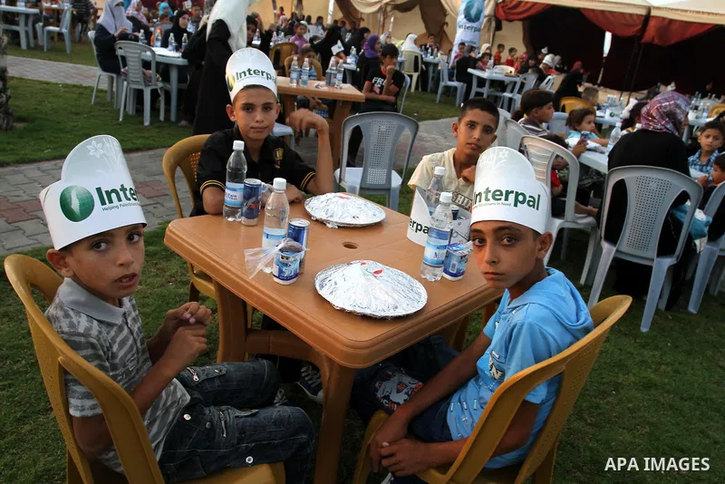 Palestinian Prime Minister in Gaza Strip, Ismail Haniya during his participation the collective meal "Iftar" with the orphans in the holiest month of Ramadan, where sponsoring by the Interpal in Gaza city on Aug. 11, 201...