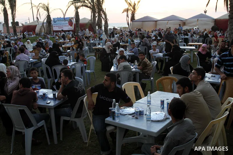 Palestinian Prime Minister in Gaza Strip, Ismail Haniya during his participation the collective meal "Iftar" with the orphans in the holiest month of Ramadan, where sponsoring by the Interpal in Gaza city on Aug. 11, 201...