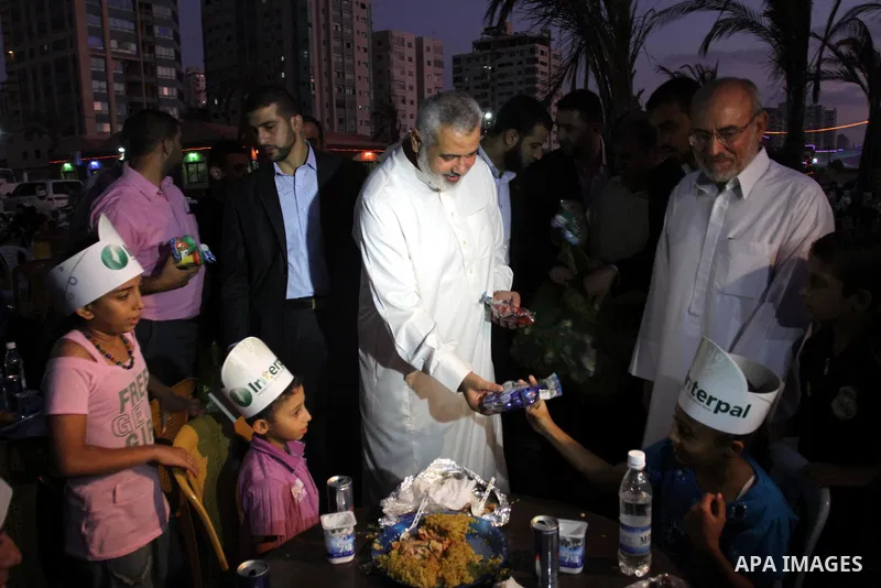 Palestinian Prime Minister in Gaza Strip, Ismail Haniya during his participation the collective meal "Iftar" with the orphans in the holiest month of Ramadan, where sponsoring by the Interpal in Gaza city on Aug. 11, 201...