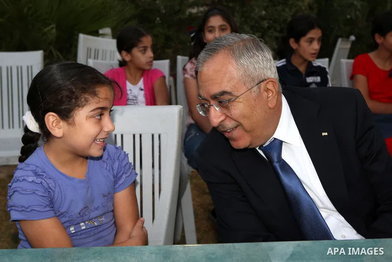 Palestinian Prime Minister, Salam Fayyad during his participation Orphans of the Orphan Care Charitable Society the meal of "Iftar" in the month of Ramadan in the West Bank city of Bethlehem on Aug. 11, 2011. Photo by Mu...
