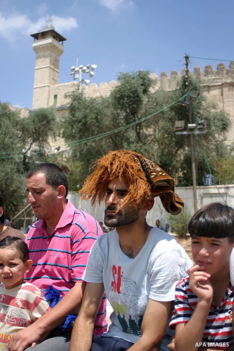Palestinian attend the second friday prayer of Islam's holy fasting month of Ramadan outside the Ibrahimi mosque, or the Tomb of the Patriarchs, in the divided West Bank city of Hebron on August 12, 2011. Photo by Najeh...