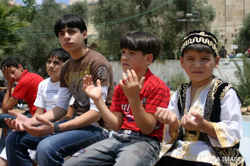 Palestinian attend the second friday prayer of Islam's holy fasting month of Ramadan outside the Ibrahimi mosque, or the Tomb of the Patriarchs, in the divided West Bank city of Hebron on August 12, 2011. Photo by Najeh...