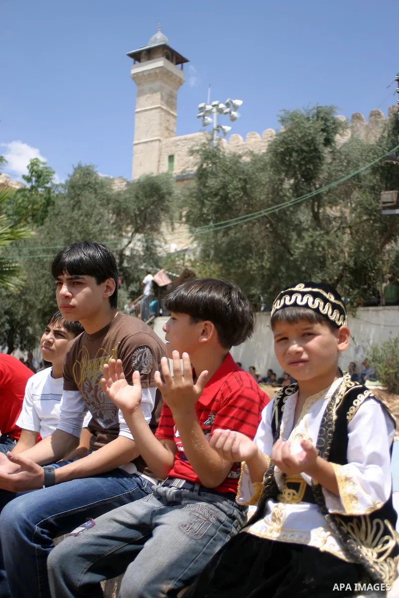 Palestinian attend the second friday prayer of Islam's holy fasting month of Ramadan outside the Ibrahimi mosque, or the Tomb of the Patriarchs, in the divided West Bank city of Hebron on August 12, 2011. Photo by Najeh...