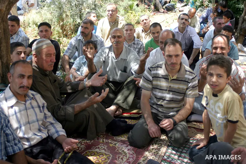 Palestinian attend the second friday prayer of Islam's holy fasting month of Ramadan outside the Ibrahimi mosque, or the Tomb of the Patriarchs, in the divided West Bank city of Hebron on August 12, 2011. Photo by Najeh...