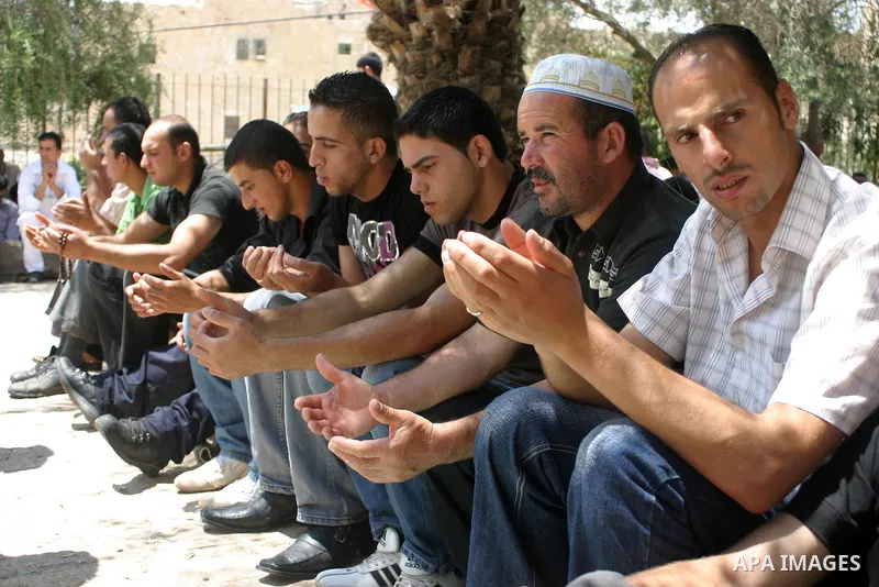 Palestinian attend the second friday prayer of Islam's holy fasting month of Ramadan outside the Ibrahimi mosque, or the Tomb of the Patriarchs, in the divided West Bank city of Hebron on August 12, 2011. Photo by Najeh...