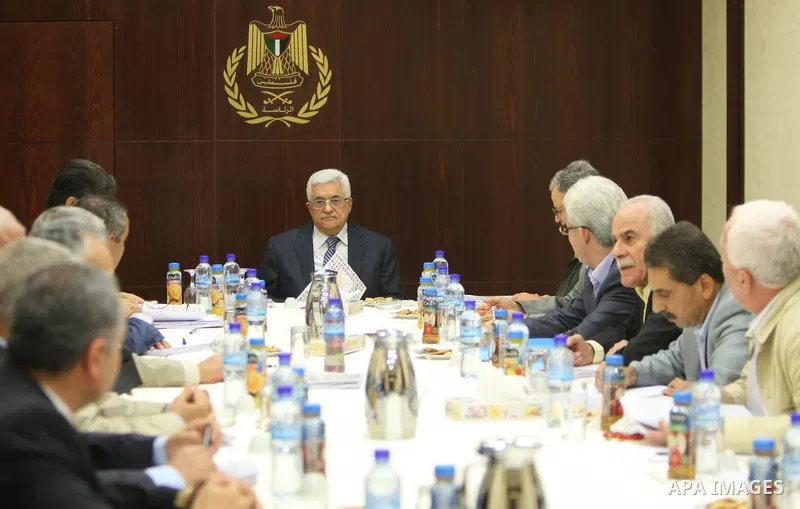 Palestinian President Mahmoud Abbas (C) as he holds a map of the world's flags while speaking during a meeting of the Central Committee of Fatah in the West Bank Bank town of Ramallah on 11 August 2011. In August the Pal...