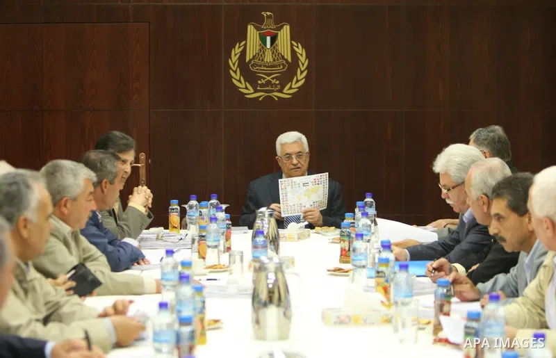 Palestinian President Mahmoud Abbas (C) as he holds a map of the world's flags while speaking during a meeting of the Central Committee of Fatah in the West Bank Bank town of Ramallah on 11 August 2011. In August the Pal...