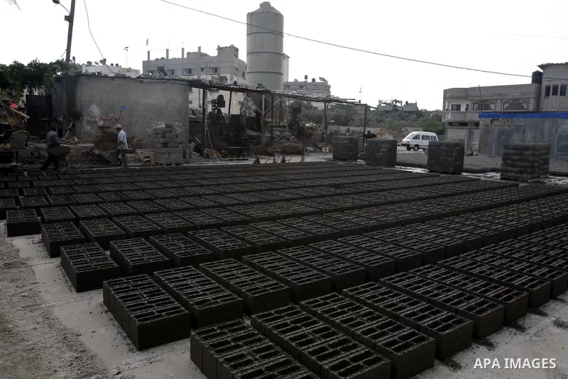 Palestinian workers use large stones for building houses in al-shejaeya camp, northern Gaza Strip on Aug. 13, 2011, as the Palestinian territory continues to lack most construction materials since the start of the siege...