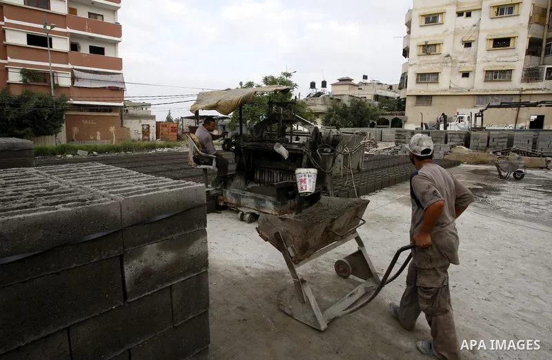 Palestinian workers use large stones for building houses in al-shejaeya camp, northern Gaza Strip on Aug. 13, 2011, as the Palestinian territory continues to lack most construction materials since the start of the siege...