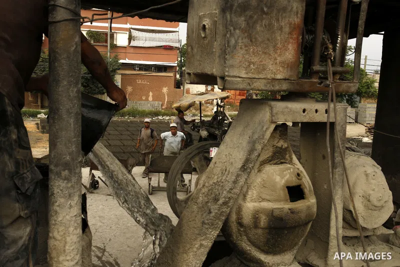 Palestinian workers use large stones for building houses in al-shejaeya camp, northern Gaza Strip on Aug. 13, 2011, as the Palestinian territory continues to lack most construction materials since the start of the siege...