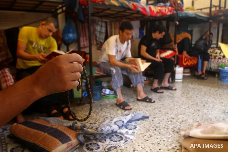 Palestinian prisoners read the holy Koran in a Hamas-run jail on the fourteenth day during the holy month of Ramadan in Gaza City on Aug. 14, 2011. Muslims around the world are observing the holy fasting month of Ramadan...