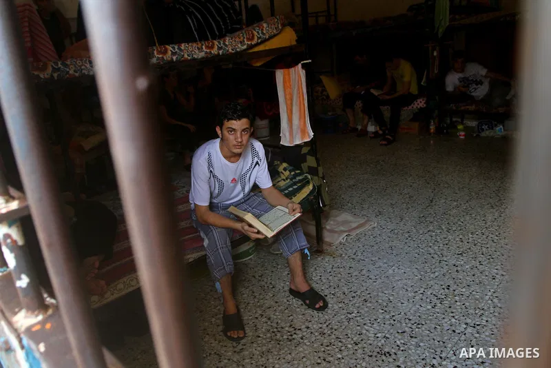 A Palestinian prisoner reads the holy Koran in a Hamas-run jail on the fourteenth day during the holy month of Ramadan in Gaza City on Aug. 14, 2011. Muslims around the world are observing the holy fasting month of Ramad...