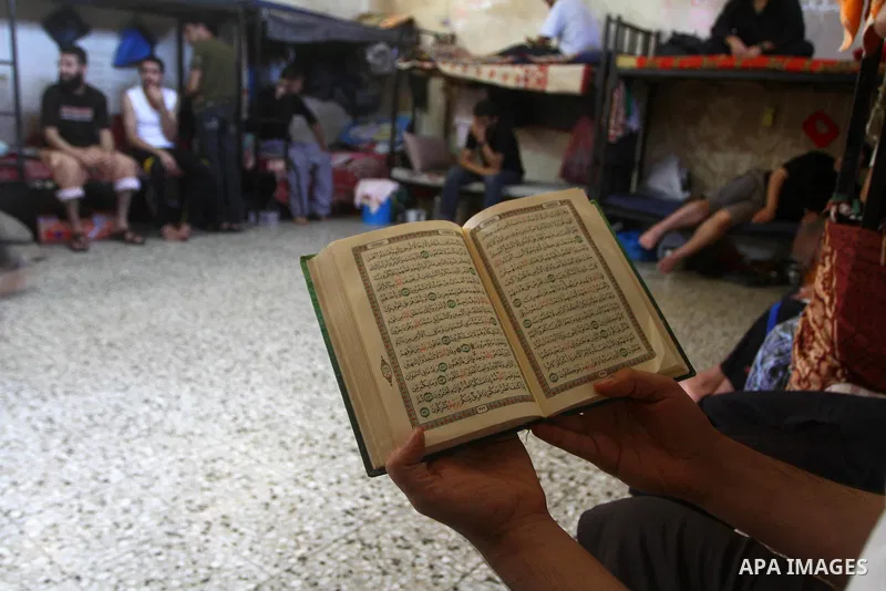 A Palestinian prisoner reads the holy Koran in a Hamas-run jail on the fourteenth day during the holy month of Ramadan in Gaza City on Aug. 14, 2011. Muslims around the world are observing the holy fasting month of Ramad...