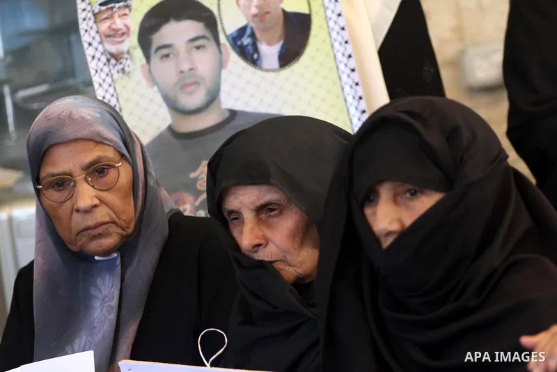 Palestinian women hold pictures of their prisoned relatives in Israeli jails as they gather in a weekly activity calling for their liberty at the Red Cross headquarters in Gaza City on Aug.15, 2011. About 7000 prisoners...