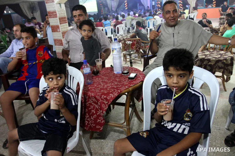 Palestinian Youths and boys follow the match between Barcelona and Real Madrid Super Cup in a cafe yesterday evening in Gaza City on Aug. 14, 2011. Photo by Mohammed Asad