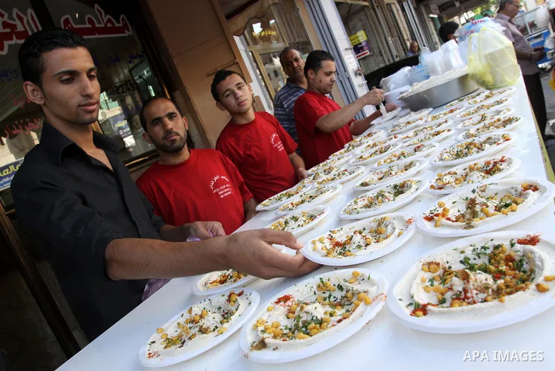 Palestinian vendors sell chickpeas in their shop in Gaza City on Aug. 15, 2011. Muslims around the world abstain from eating, drinking and conducting sexual relations from sunrise to sunset during Ramadan, the holiest mo...