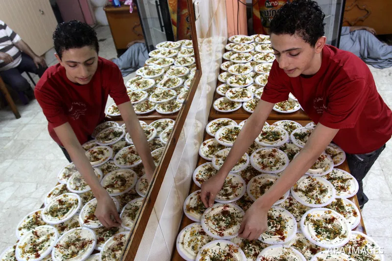 Palestinian vendors sell chickpeas in their shop in Gaza City on Aug. 15, 2011. Muslims around the world abstain from eating, drinking and conducting sexual relations from sunrise to sunset during Ramadan, the holiest mo...