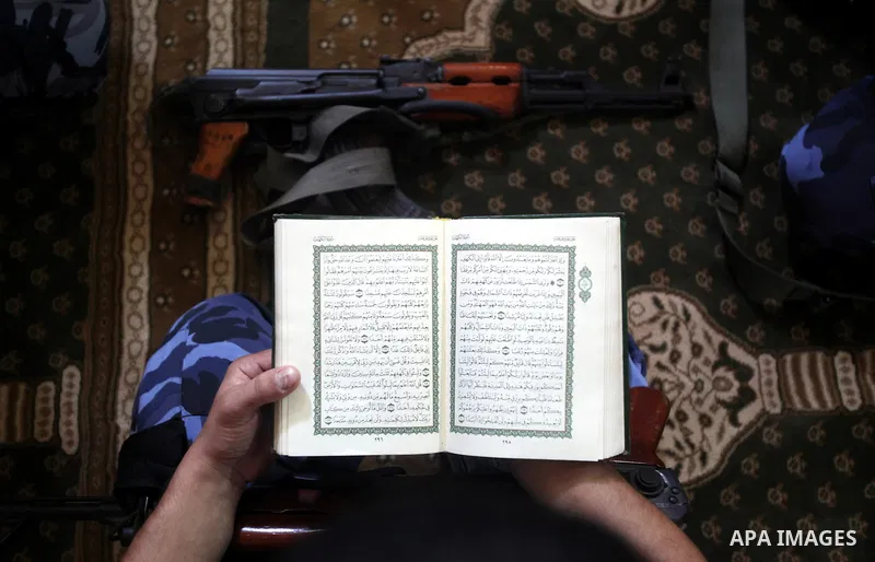 A Palestinian member of Hamas security reads a copy of the holy Koran in a Mosque during the holy month of Ramadan in Gaza Strip on 14 August 2011. Muslims around the world are observing the holy fasting month of Ramadan...