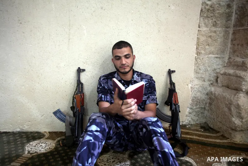 A Palestinian member of Hamas security reads a copy of the holy Koran in a Mosque during the holy month of Ramadan in Gaza Strip on 14 August 2011. Muslims around the world are observing the holy fasting month of Ramadan...