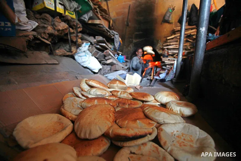 A Palestinian baker prepares loaves of bread at his traditional bakery in the holy month of Ramadan in Gaza City on Aug. 15, 2011. Muslims around the world abstain from eating, drinking and conducting sexual relations fr...