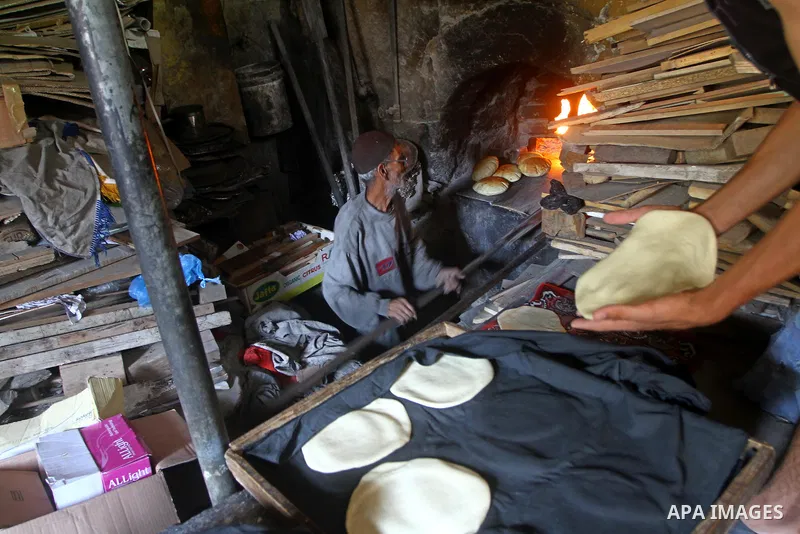 A Palestinian baker prepares loaves of bread at his traditional bakery in the holy month of Ramadan in Gaza City on Aug. 15, 2011. Muslims around the world abstain from eating, drinking and conducting sexual relations fr...