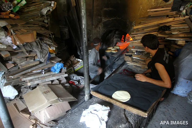 A Palestinian baker prepares loaves of bread at his traditional bakery in the holy month of Ramadan in Gaza City on Aug. 15, 2011. Muslims around the world abstain from eating, drinking and conducting sexual relations fr...