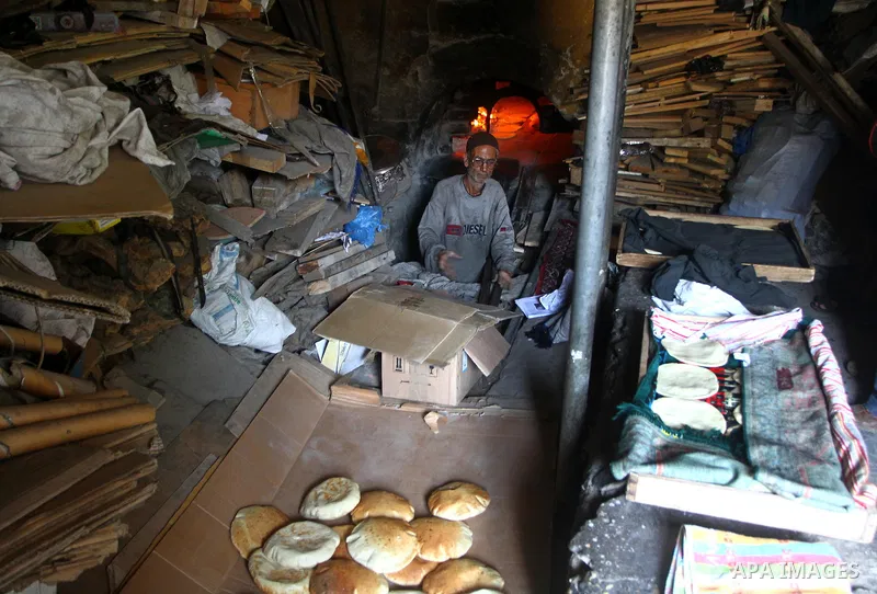 A Palestinian baker prepares loaves of bread at his traditional bakery in the holy month of Ramadan in Gaza City on Aug. 15, 2011. Muslims around the world abstain from eating, drinking and conducting sexual relations fr...