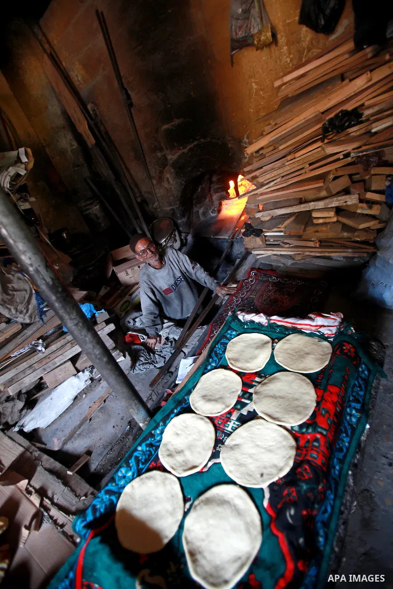 A Palestinian baker prepares loaves of bread at his traditional bakery in the holy month of Ramadan in Gaza City on Aug. 15, 2011. Muslims around the world abstain from eating, drinking and conducting sexual relations fr...