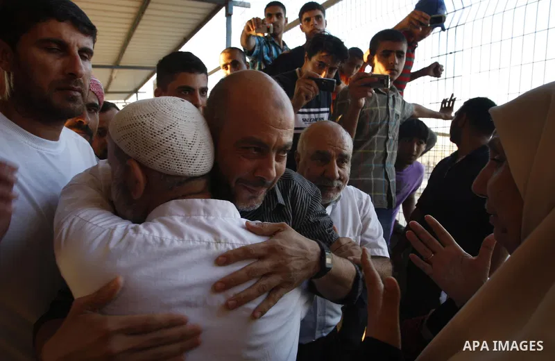 Palestinians welcome back of prisoner Ahmed Abu El-Kass released from Israeli prisons at the Erez checkpoint in the northern Gaza Strip, following their release at the Erez crossing by Israeli border police, 15 August 20...