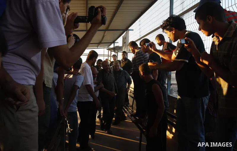 Palestinians welcome back of prisoner Ahmed Abu El-Kass released from Israeli prisons at the Erez checkpoint in the northern Gaza Strip, following their release at the Erez crossing by Israeli border police, 15 August 20...