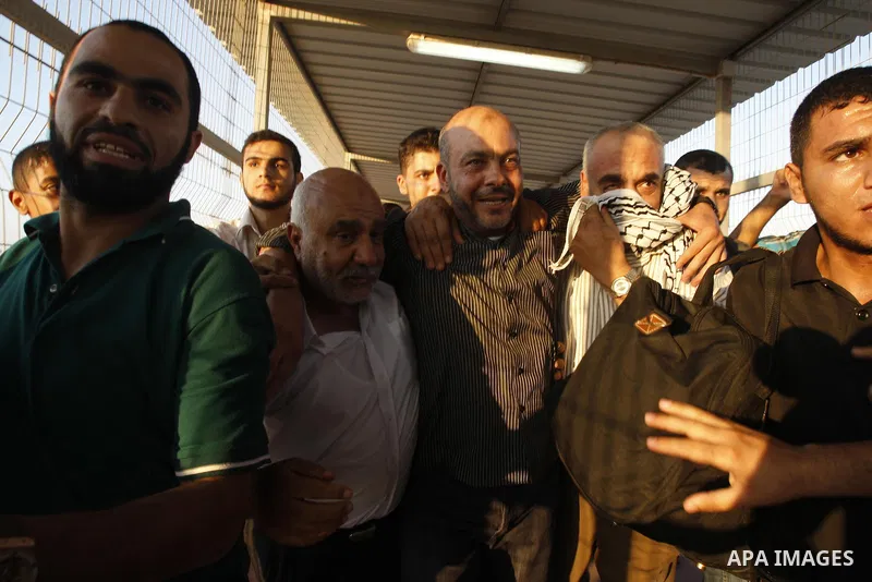 Palestinians welcome back of prisoner Ahmed Abu El-Kass released from Israeli prisons at the Erez checkpoint in the northern Gaza Strip, following their release at the Erez crossing by Israeli border police, 15 August 20...