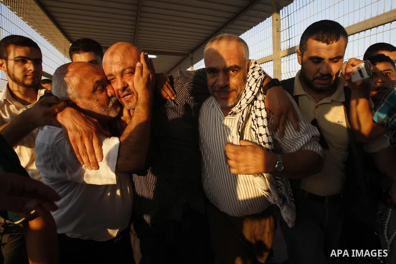 Palestinians welcome back of prisoner Ahmed Abu El-Kass released from Israeli prisons at the Erez checkpoint in the northern Gaza Strip, following their release at the Erez crossing by Israeli border police, 15 August 20...