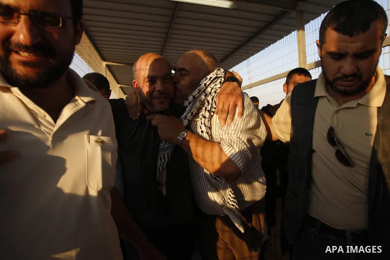 Palestinians welcome back of prisoner Ahmed Abu El-Kass released from Israeli prisons at the Erez checkpoint in the northern Gaza Strip, following their release at the Erez crossing by Israeli border police, 15 August 20...