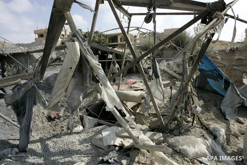 Palestinians inspect the damage outside a smuggling tunnel following an overnight Israeli airstrike in Rafah, on the border between Egypt and southern Gaza Strip, Tuesday on Aug. 16, 2011. after one Palestinian was kille...
