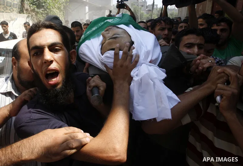 Palestinian mourners carry the body of Moussa Shtewi during his funeral in Gaza City on August 16, 2011 after he was killed and seven injured by overnight Israeli air strikes across the Gaza Strip, Palestinian medics sai...