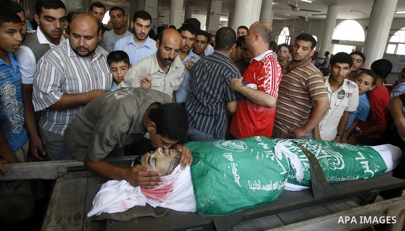 Palestinian relatives of Moussa Shtewi, 29, kiss during his funeral in Gaza City, Tuesday, Aug. 16, 2011. Israeli aircraft struck five targets in the Hamas-ruled Gaza Strip on Tuesday, killing Sh'tehwi and wounding four...