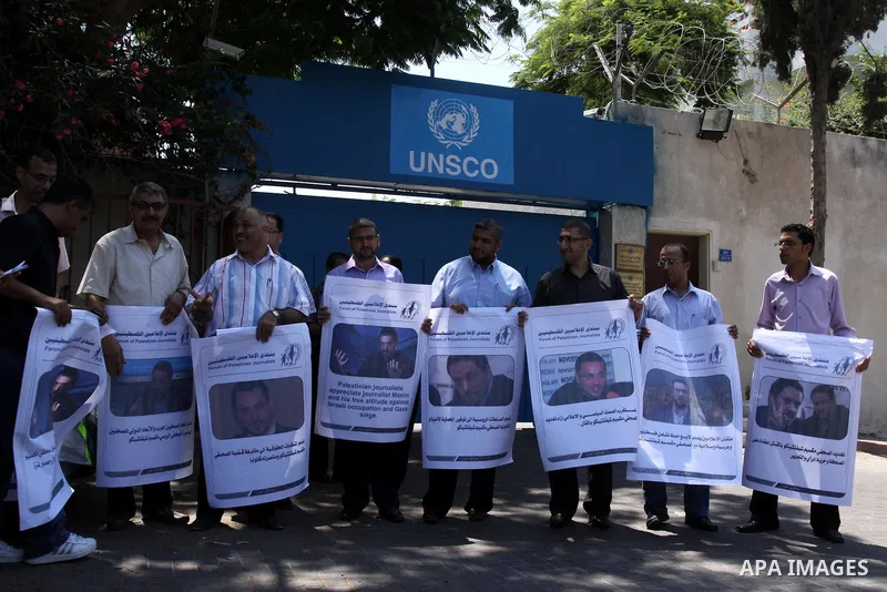 Palestinian journalists take part in a protest in support with the Russian journalist, Maxim infront of UNSCO in Gaza city on Aug. 16, 2011. where he threatened with death by one of the leaders of the Russian Jewish Cong...