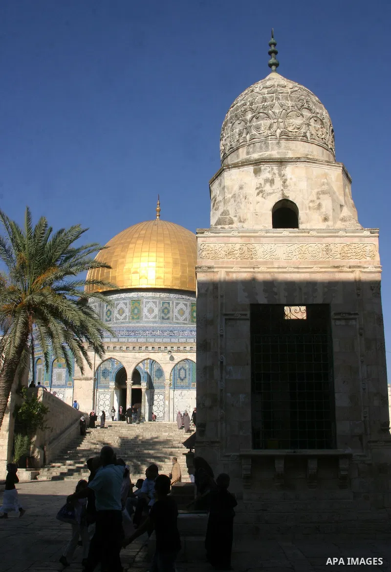 Palestinians walk in front of the Dome of the Rock at the al-Aqsa Mosque compound in Jerusalem's Old City on August 16,2011, during the sixteenth day of the Muslim holy month of Ramadan. Photo by Mahfouz Abu Turk
