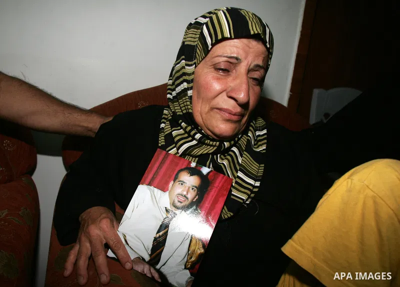 Relatives of the Palestinian Amin Taleb Dabash, 32, mourn over his body during his funeral in the village of Sur Baher in east Jerusalem on August 17,2011. Dabash was killed after an Israeli military jeep hit him . Photo...